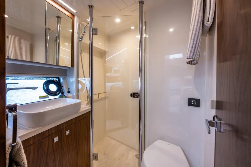 Slide: The Image of Luxurious bathroom interior of 2026 Riviera 505 SUV yacht, featuring modern fixtures and elegant design. - 48