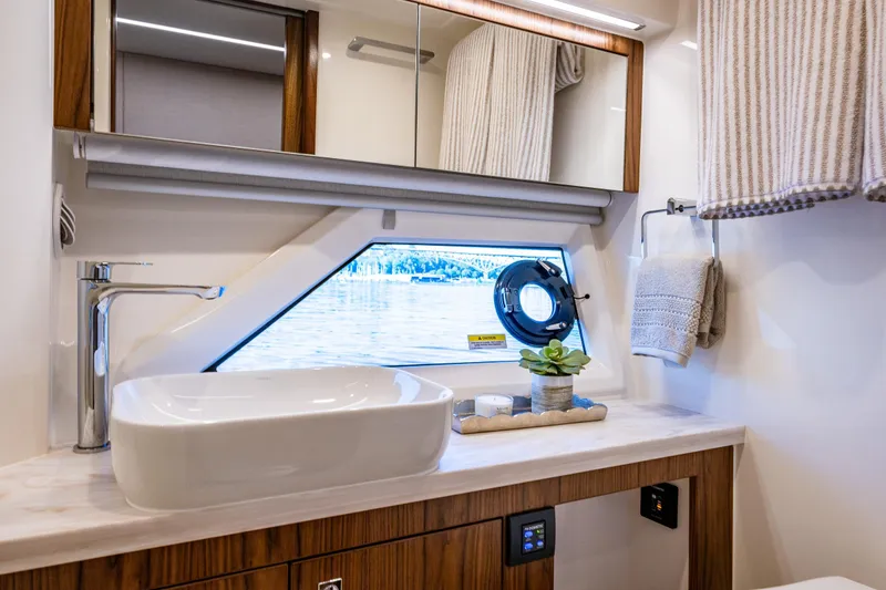 Slide: The Image of Luxurious bathroom interior of 2026 Riviera 505 SUV yacht with modern sink and window view. - 49