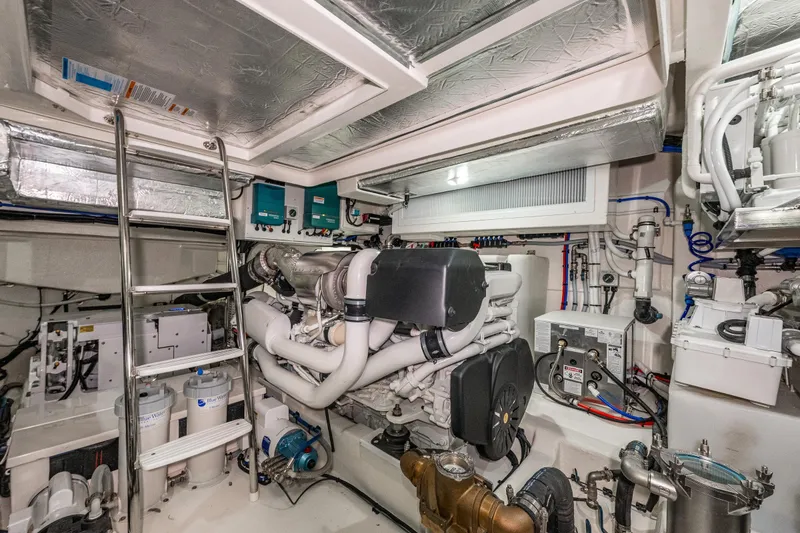 Slide: The Image of Engine room of 2026 Riviera 505 SUV yacht, featuring advanced machinery and equipment. - 53