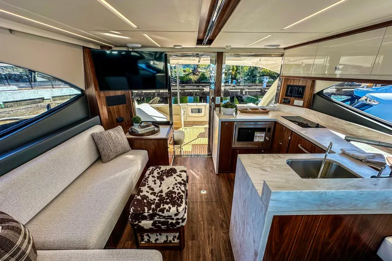 Slide: The Image of 2026 Riviera 505 SUV luxury yacht on clear blue water. - 9