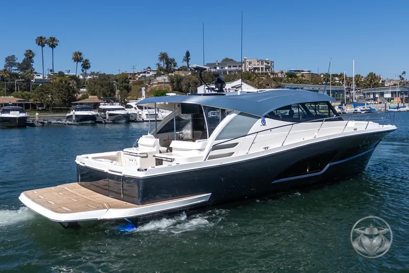 Slide: The Image of 2025 Riviera 465 SUV luxury yacht cruising in a marina with clear blue skies. - 21