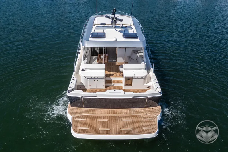 Slide: The Image of 2025 Riviera 465 SUV yacht cruising on open water, showcasing spacious deck and modern design. - 24