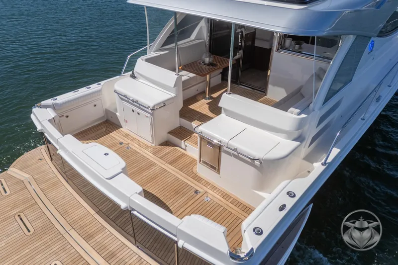 Slide: The Image of 2025 Riviera 465 SUV yacht with spacious teak deck and elegant seating area. - 27