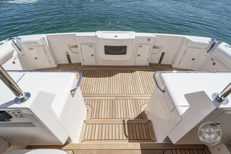 Slide: The Image of 2025 Riviera 465 SUV yacht deck with teak flooring and ocean view. - 30