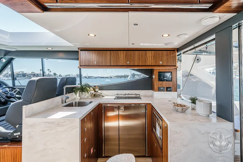 Slide: The Image of Luxurious interior of 2025 Riviera 465 SUV yacht with modern kitchen and scenic views. - 38