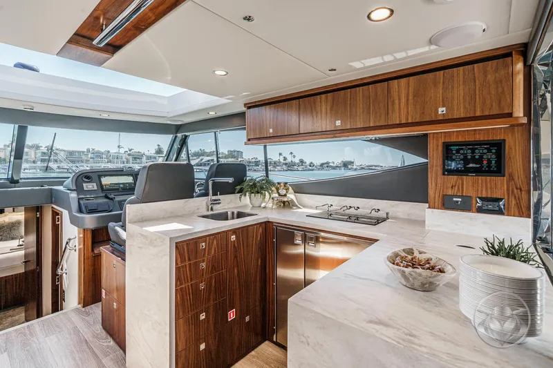Slide: The Image of Luxurious interior of 2025 Riviera 465 SUV yacht with modern kitchen and helm station. - 39