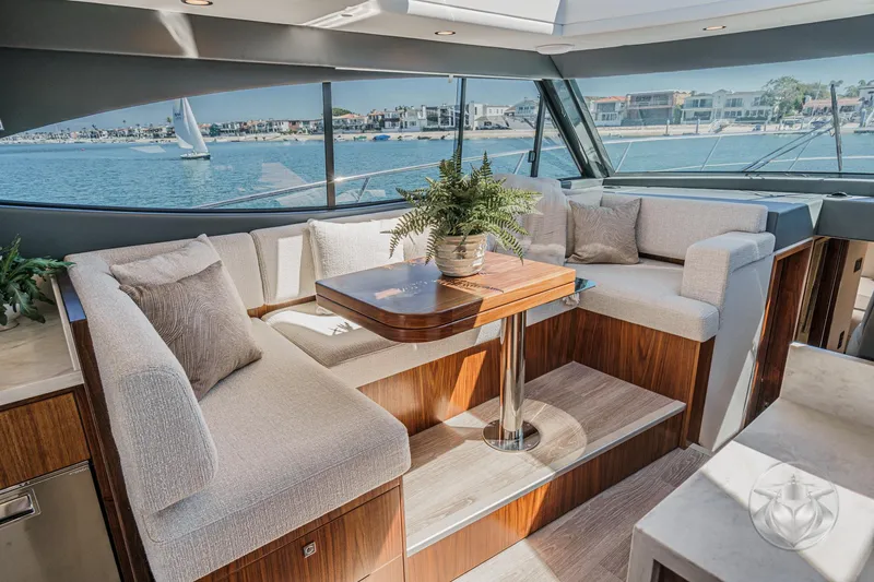 Slide: The Image of Luxurious interior of 2025 Riviera 465 SUV yacht with elegant seating and scenic ocean view. - 42