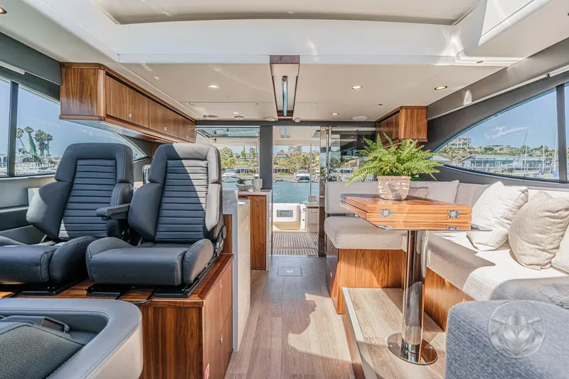 Slide: The Image of Luxurious interior of 2025 Riviera 465 SUV yacht with plush seating and elegant wood finishes. - 44