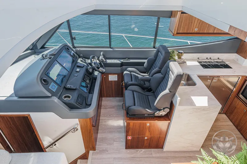 Slide: The Image of Interior of 2025 Riviera 465 SUV yacht with modern helm and luxurious seating. - 45