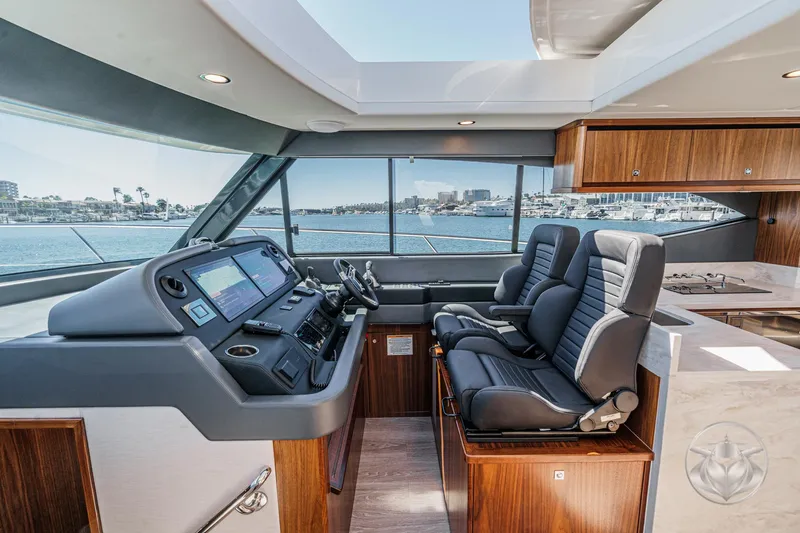 Slide: The Image of 2025 Riviera 465 SUV yacht interior with modern helm, dual seats, and panoramic windows. - 46