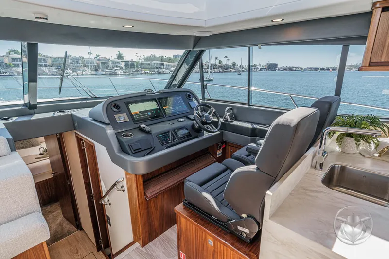 Slide: The Image of Interior of 2025 Riviera 465 SUV yacht with modern helm and ocean view. - 5