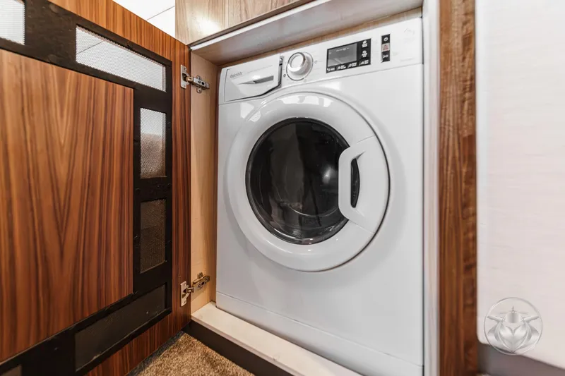 Slide: The Image of Washing machine inside 2025 Riviera 465 SUV, wooden cabinet detail. - 53