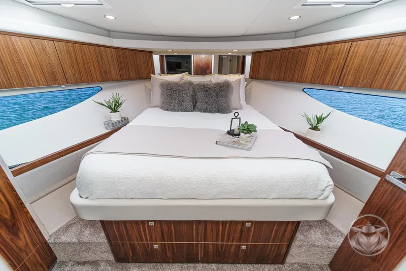 Slide: The Image of Luxurious bedroom interior of 2025 Riviera 465 SUV yacht with elegant wood finishes. - 6