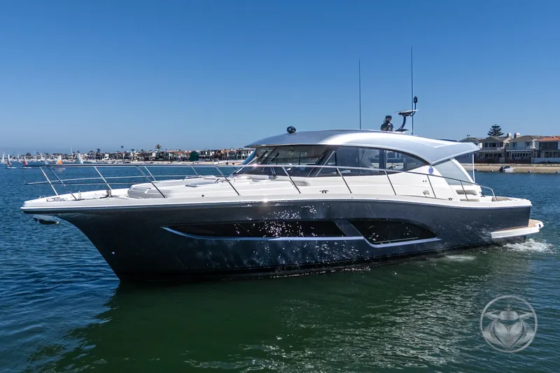 Slide: The Image of 2025 Riviera 465 SUV yacht cruising on a sunny day in a coastal area. - 8