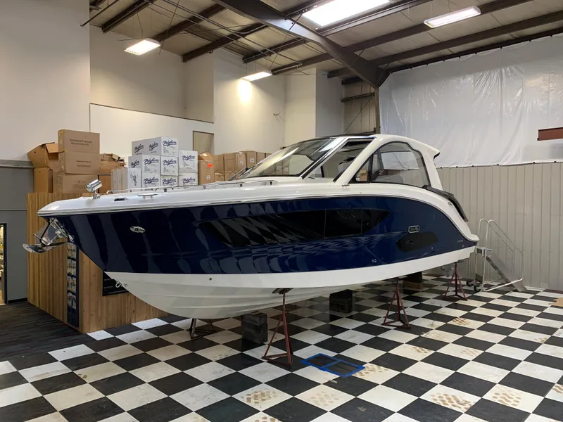 Slide: The Image of 2023 Sea Ray Sundancer 370 OB in showroom on checkered floor. - 1