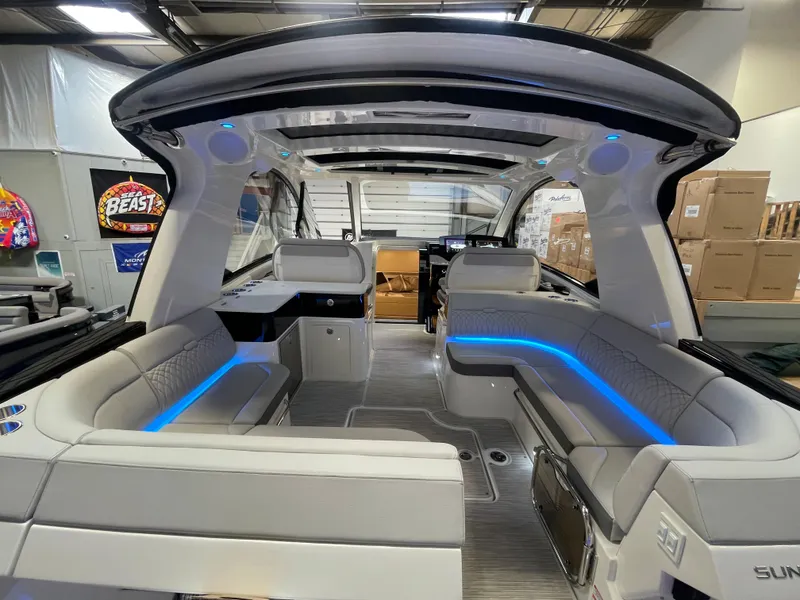 Slide: The Image of 2023 Sea Ray Sundancer 370 OB interior with modern seating and blue LED lighting. - 10