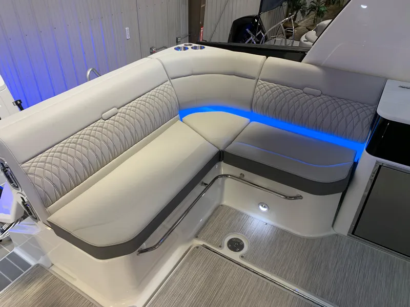 Slide: The Image of Luxurious seating area on the 2023 Sea Ray Sundancer 370 OB with blue LED lighting. - 11