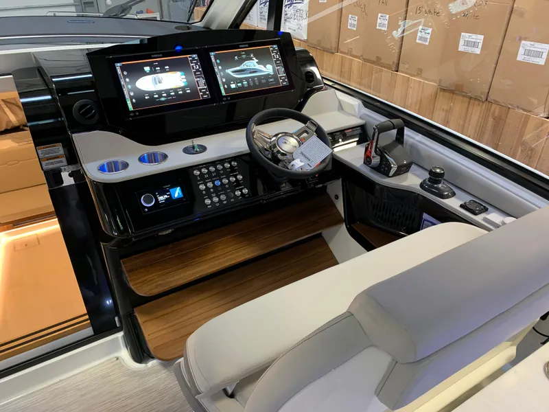 Slide: The Image of 2023 Sea Ray Sundancer 370 OB helm with advanced navigation displays and controls. - 15