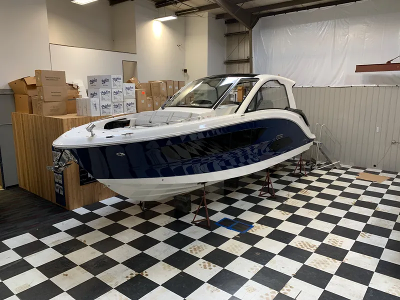Slide: The Image of 2023 Sea Ray Sundancer 370 OB in showroom on checkered floor. - 2