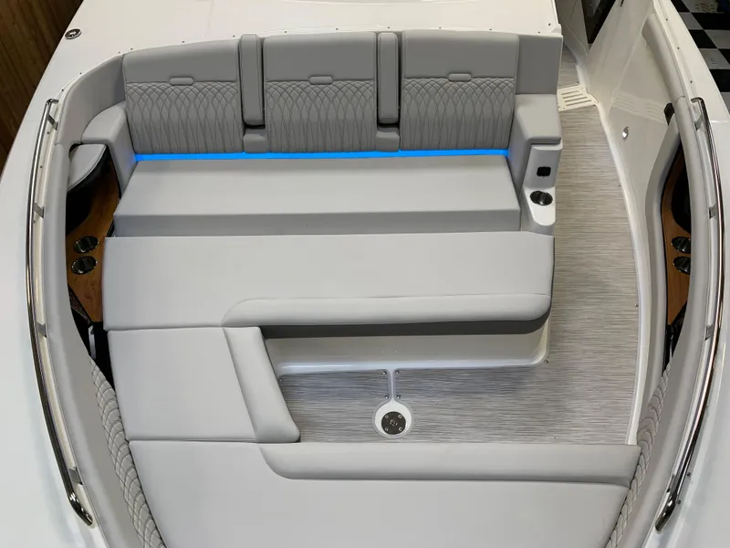 Slide: The Image of 2023 Sea Ray Sundancer 370 OB boat interior with gray seating and blue accent lighting. - 29