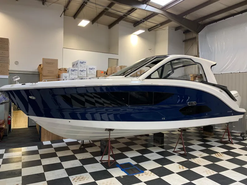 Slide: The Image of 2023 Sea Ray Sundancer 370 OB in showroom on checkered floor. - 3