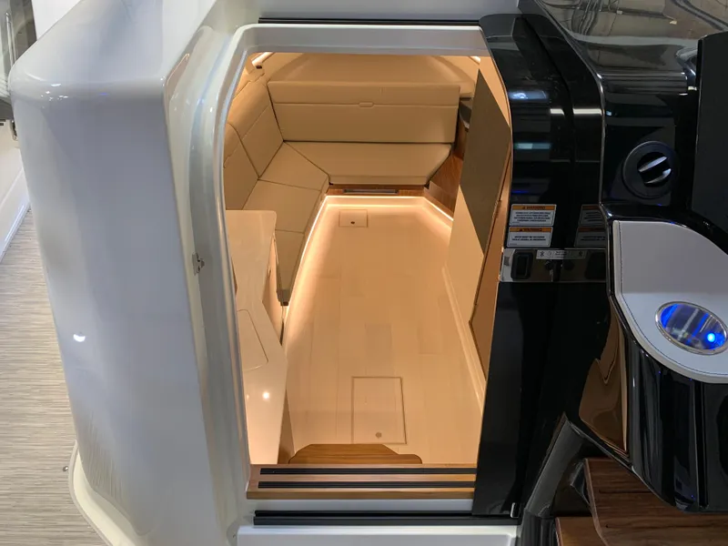 Slide: The Image of 2023 Sea Ray Sundancer 370 OB cabin interior with modern lighting and seating. - 31