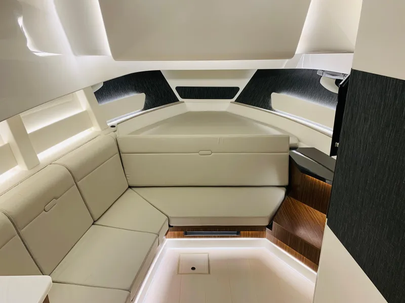 Slide: The Image of Interior of 2023 Sea Ray Sundancer 370 OB, featuring modern seating and ambient lighting. - 32