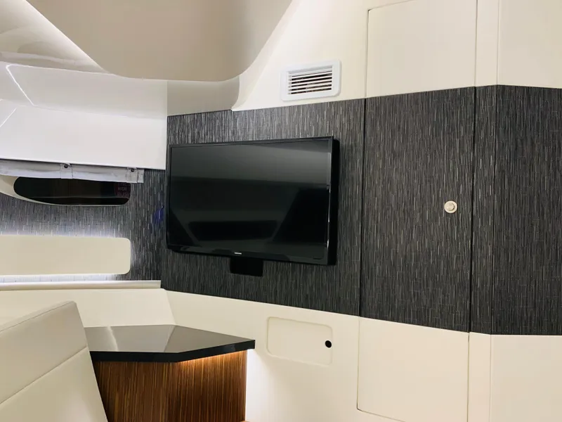 Slide: The Image of 2023 Sea Ray Sundancer 370 OB interior with mounted TV and modern design. - 34