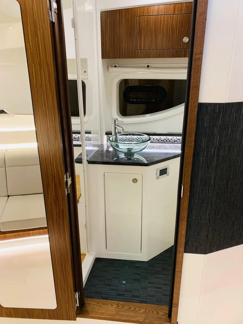 Slide: The Image of 2023 Sea Ray Sundancer 370 OB interior with modern kitchenette and seating area. - 35