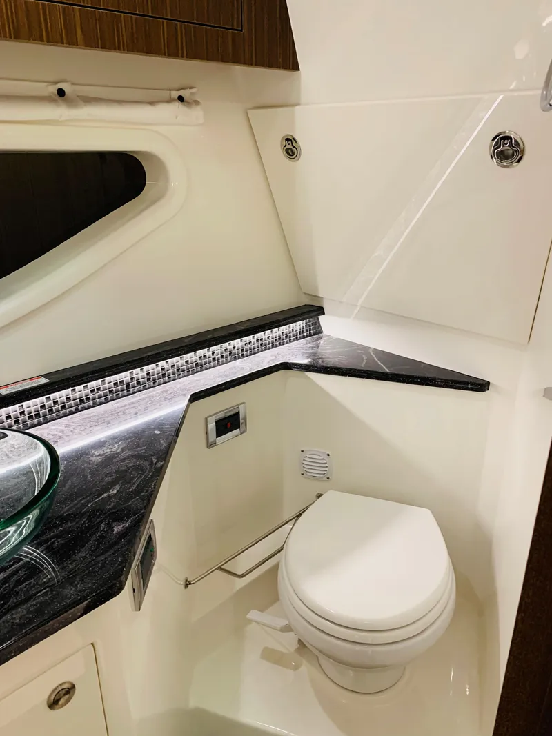 Slide: The Image of 2023 Sea Ray Sundancer 370 OB bathroom with modern fixtures and sleek design. - 36