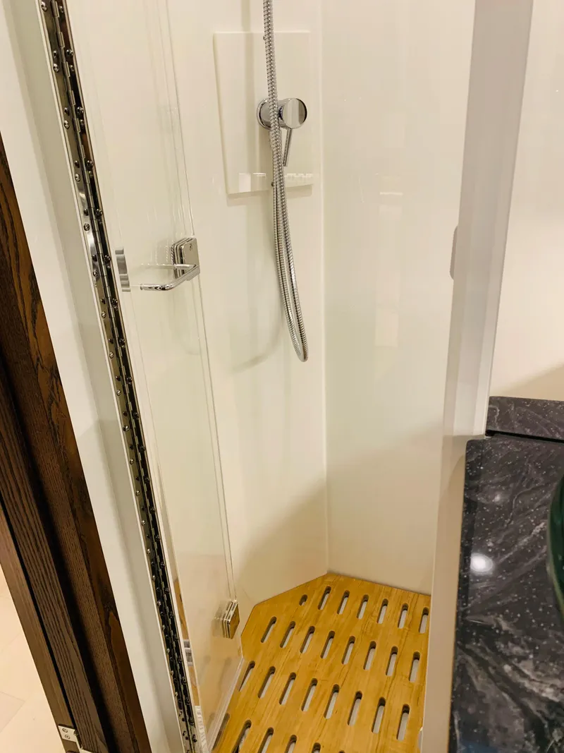 Slide: The Image of 2023 Sea Ray Sundancer 370 OB shower with wooden floor and modern fixtures. - 38