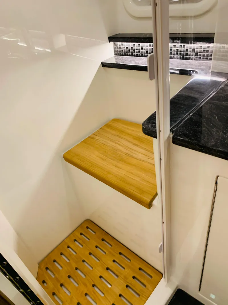 Slide: The Image of 2023 Sea Ray Sundancer 370 OB interior with wooden accents and modern design. - 39