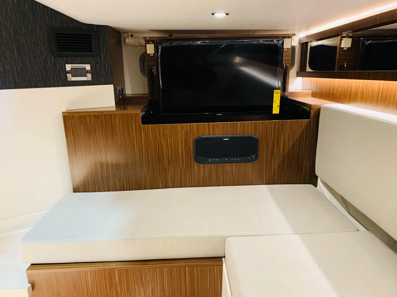 Slide: The Image of Interior cabin of 2023 Sea Ray Sundancer 370 OB with TV and seating area. - 43