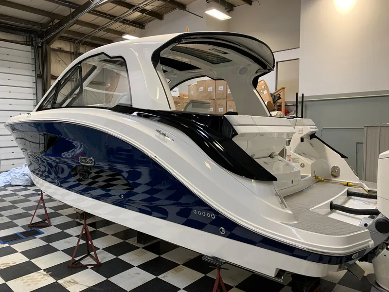 Slide: The Image of 2023 Sea Ray Sundancer 370 OB in a showroom on a checkered floor. - 5