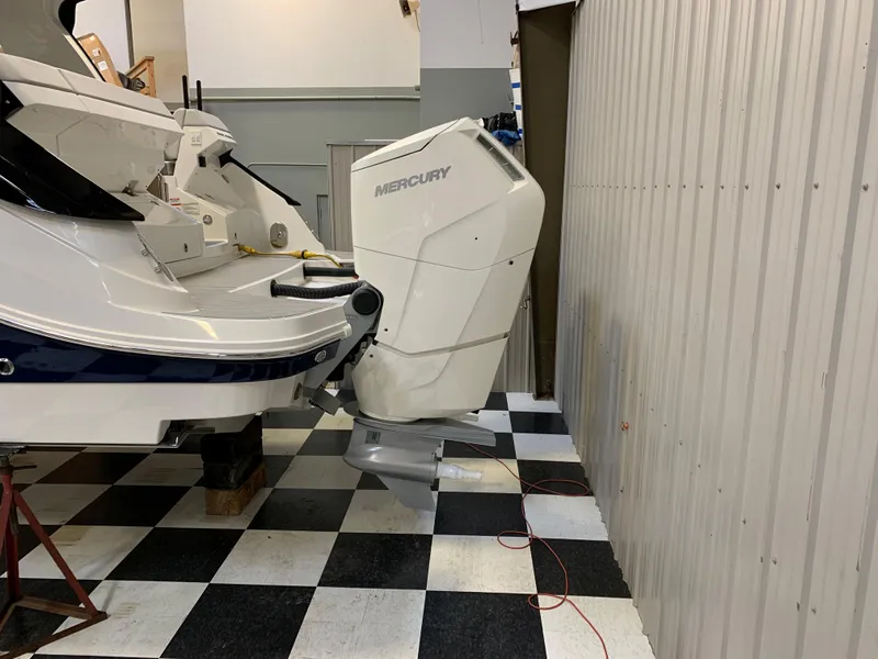 Slide: The Image of 2023 Sea Ray Sundancer 370 OB with Mercury outboard engine in a garage. - 6