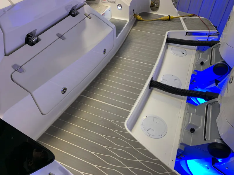 Slide: The Image of 2023 Sea Ray Sundancer 370 OB boat deck with storage compartments and blue LED lighting. - 8