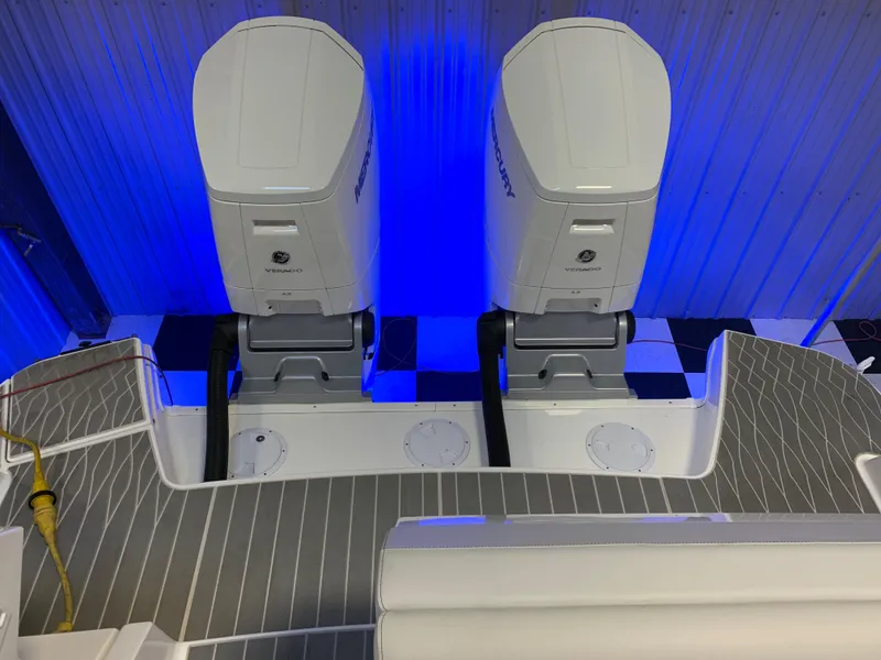 Slide: The Image of 2023 Sea Ray Sundancer 370 OB with dual outboard engines, illuminated in blue. - 9