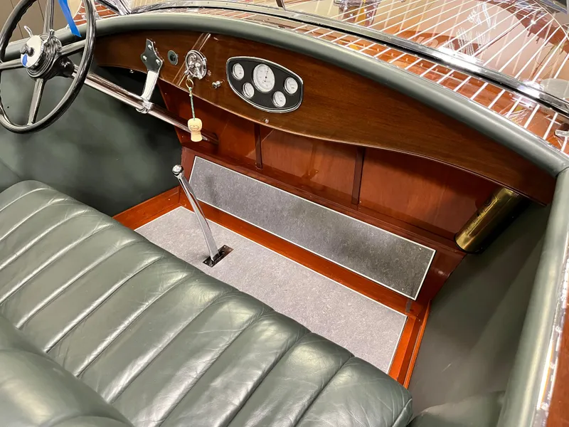 Slide: The Image of 1932 Hacker-Craft Triple Cockpit interior with vintage steering wheel and classic dashboard. - 11