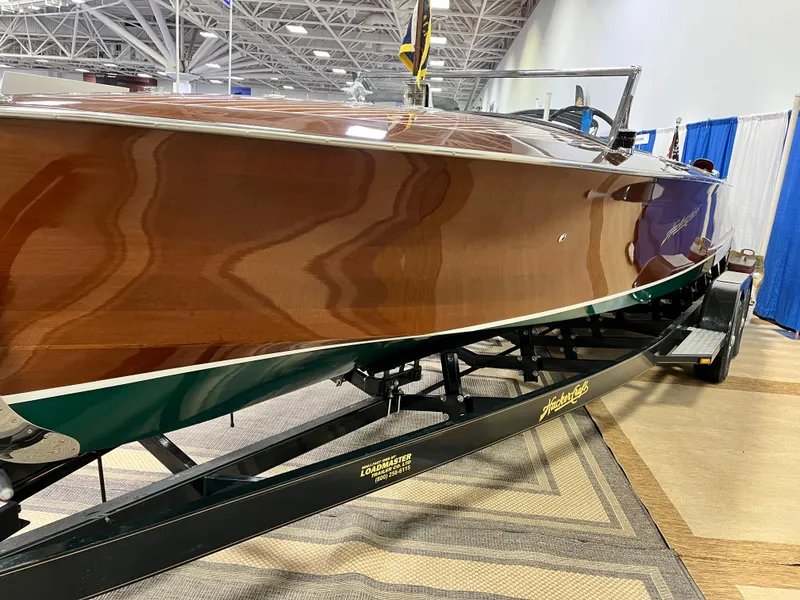 Slide: The Image of 1932 Hacker-Craft Triple Cockpit boat on display, showcasing polished wooden exterior. - 14