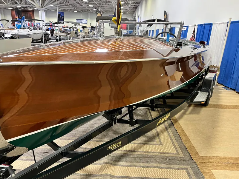 Slide: The Image of 1932 Hacker-Craft Triple Cockpit boat displayed on a trailer at an indoor exhibition. - 15