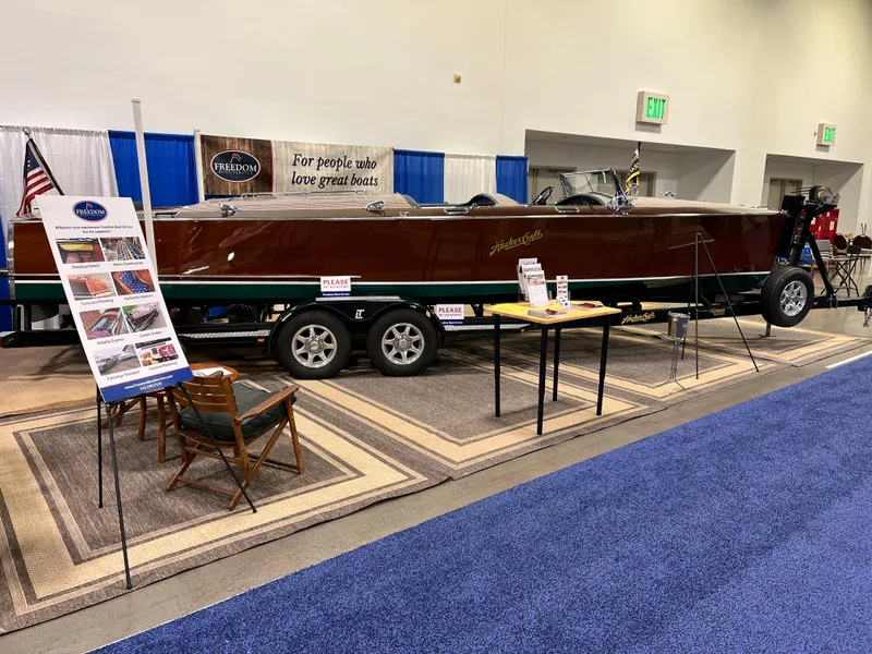 Slide: The Image of 1932 Hacker-Craft Triple Cockpit boat on display at an indoor exhibition. - 7