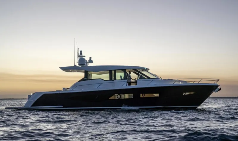 Slide: The Image of 2024 Tiara Yachts EX 60 cruising at sunset. - 1