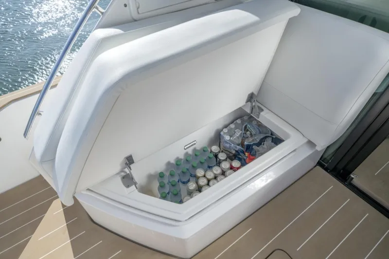 Slide: The Image of Built-in cooler on the 2024 Tiara Yachts EX 60, stocked with beverages. - 11