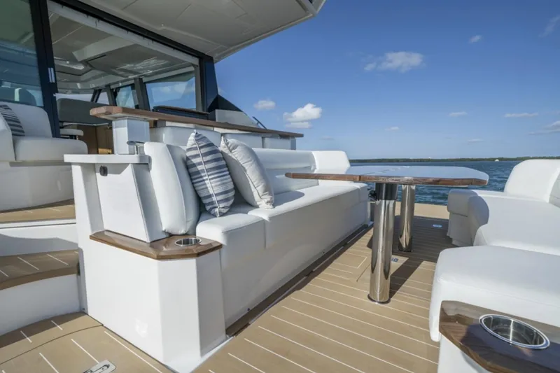 Slide: The Image of 2024 Tiara Yachts EX 60 luxury seating area with ocean view. - 21