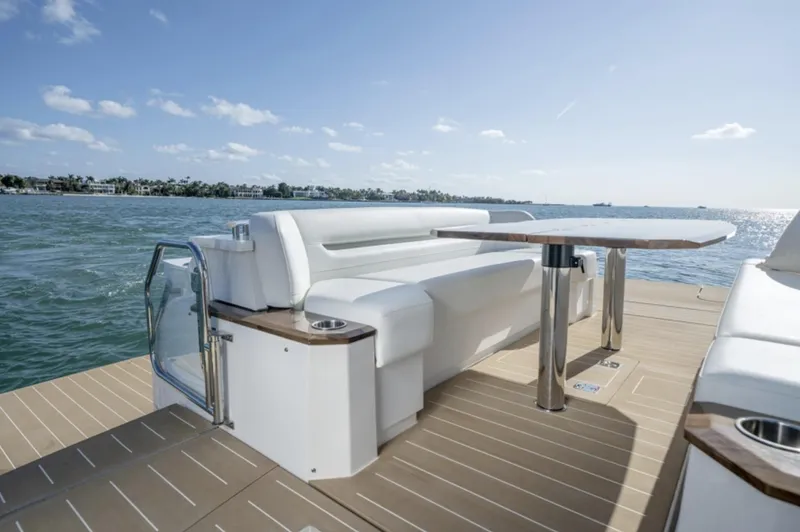 Slide: The Image of 2024 Tiara Yachts EX 60 deck with seating and table, ocean view. - 22