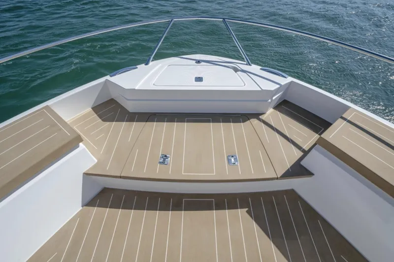 Slide: The Image of 2024 Tiara Yachts EX 60 bow deck with teak flooring and ocean view. - 23