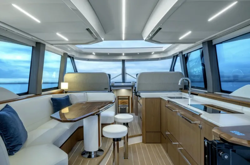 Slide: The Image of Luxurious interior of the 2024 Tiara Yachts EX 60 with modern kitchen and seating area. - 28