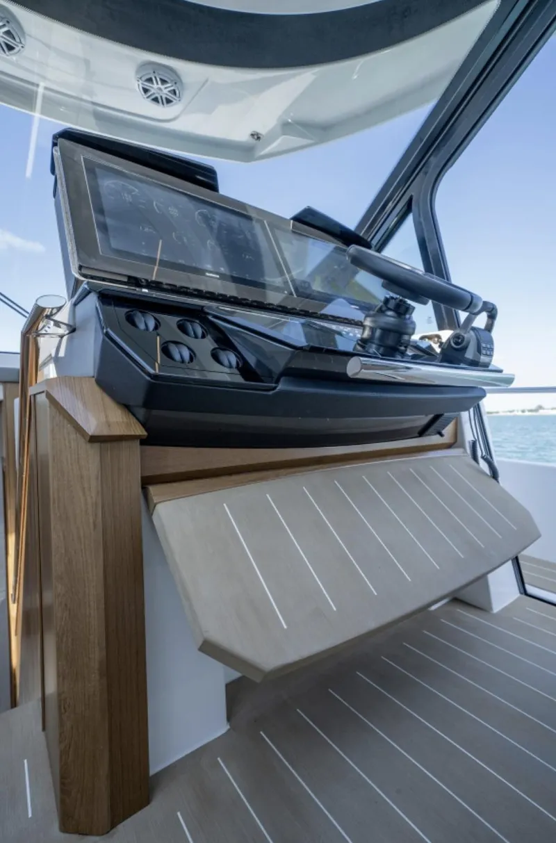 Slide: The Image of 2024 Tiara Yachts EX 60 helm station with advanced navigation controls. - 31