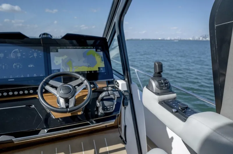 Slide: The Image of 2024 Tiara Yachts EX 60 helm with advanced navigation system and joystick control. - 32