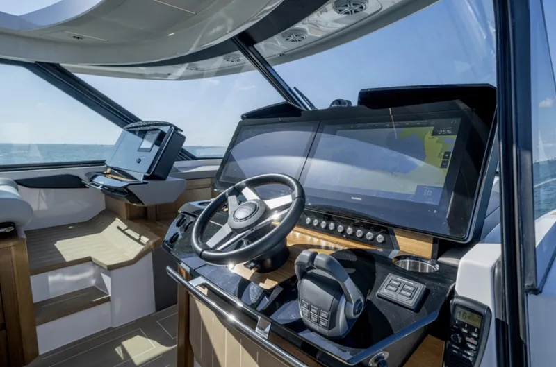 Slide: The Image of 2024 Tiara Yachts EX 60 helm station with advanced navigation systems and luxurious interior. - 33